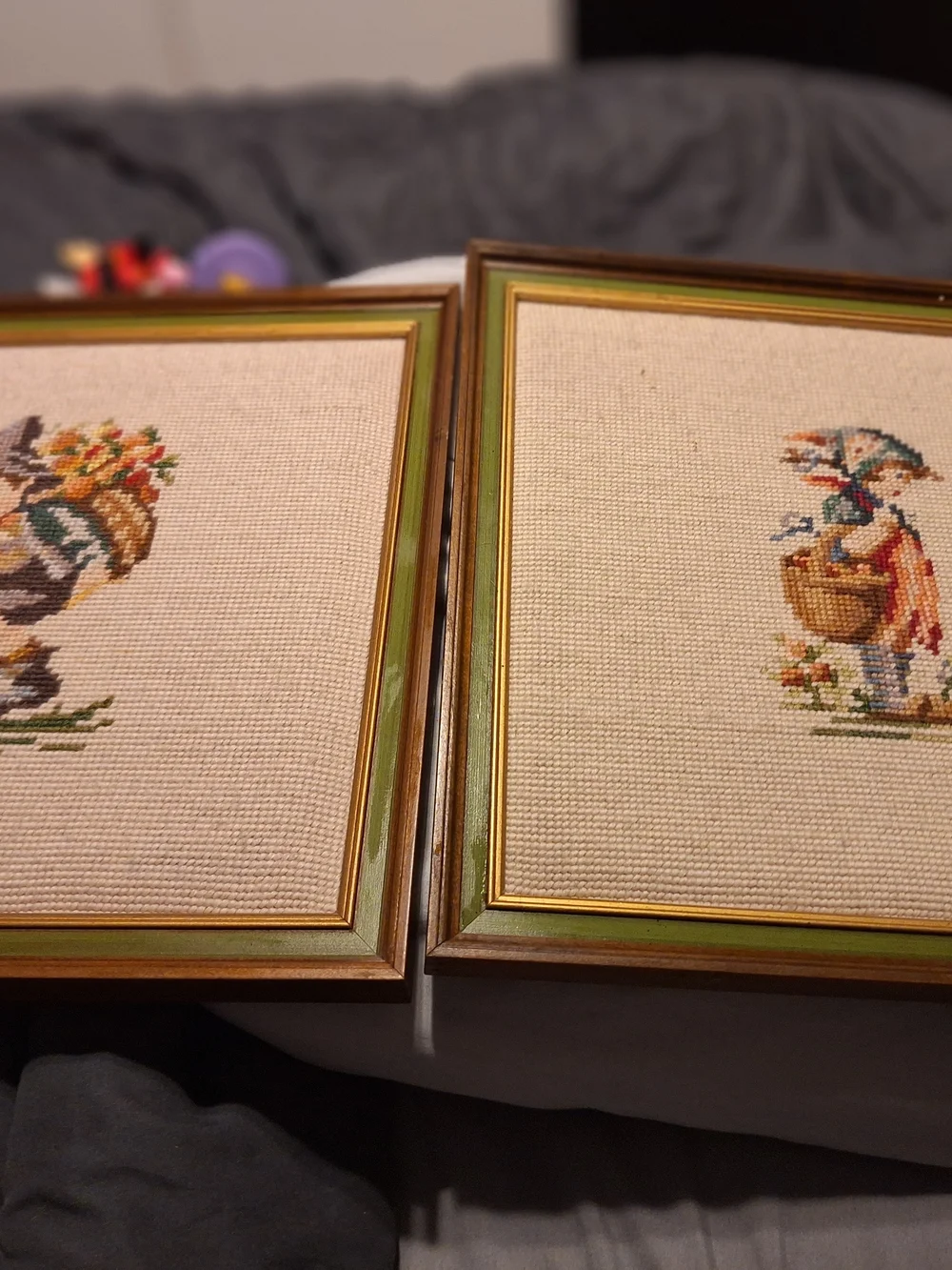 a pair of vintage Hummel framed needlepoint pictures featuring a boy a Girl